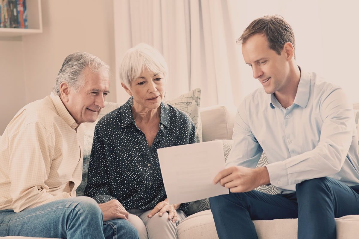 An Adapt advisor going over a care plan with an older couple
